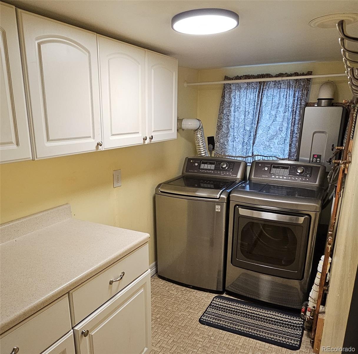306 Elm Street Leadville, CO 80461 - Photo 17 of 42 a kitchen with granite countertop cabinets washer and dryer