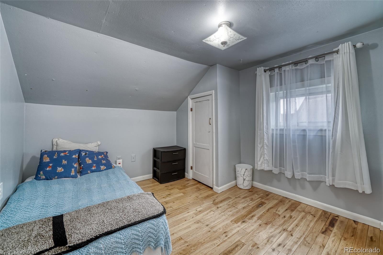 306 Elm Street Leadville, CO 80461 - Photo 24 of 42 a bedroom with a bed and a chandelier