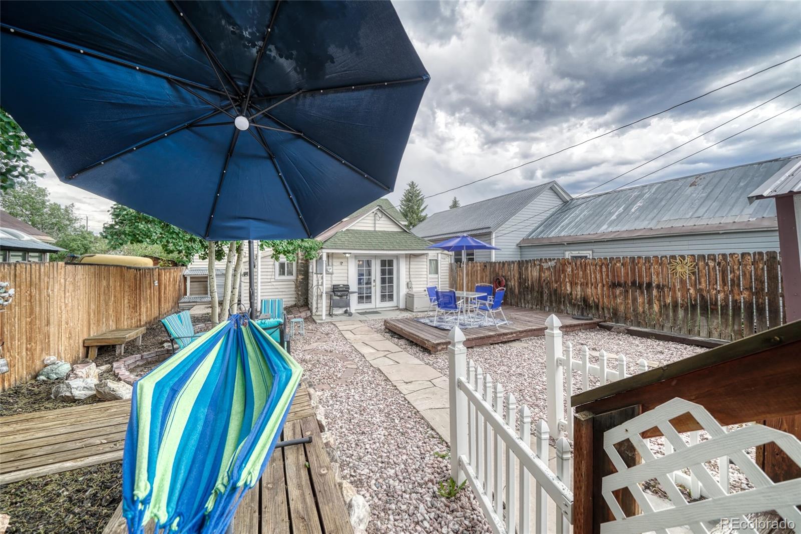 306 Elm Street Leadville, CO 80461 - Photo 32 of 42 a view of a patio with a table and chairs under an umbrella