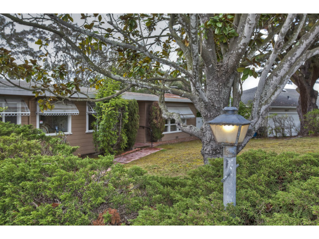 1859 Randall Road San Mateo, CA 94402 - Photo 1 of 22 a front view of a house with a yard garage and fountain