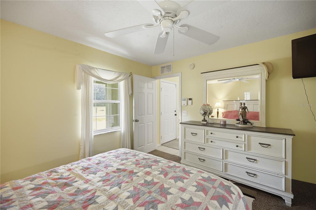 17900 Northwest 120th Avenue Road Reddick, FL 32686 - Photo 30 of 45 a bedroom with a large bed and a dresser