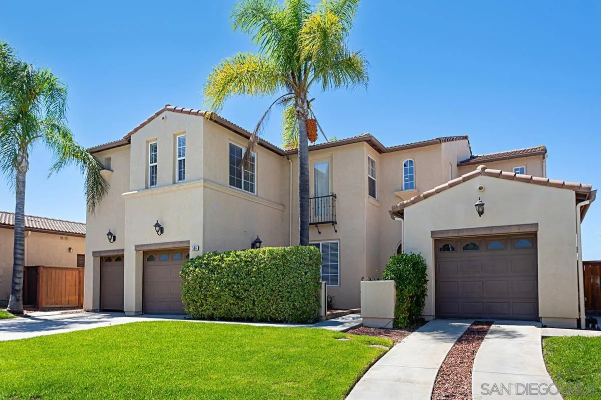 a front view of a house with a garden and yard