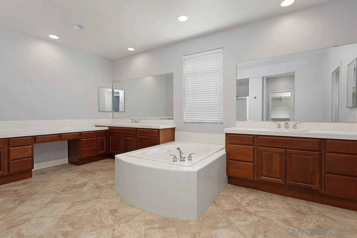 536 Echo Lane San Marcos, CA 92078 - Photo 16 of 24 a bathroom with a tub sink double vanity and mirror