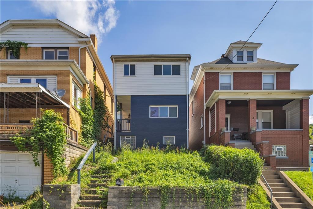 1406 Broadway Avenue McKees Rocks, PA 15136 - Photo 1 of 28 a front view of a house with garden