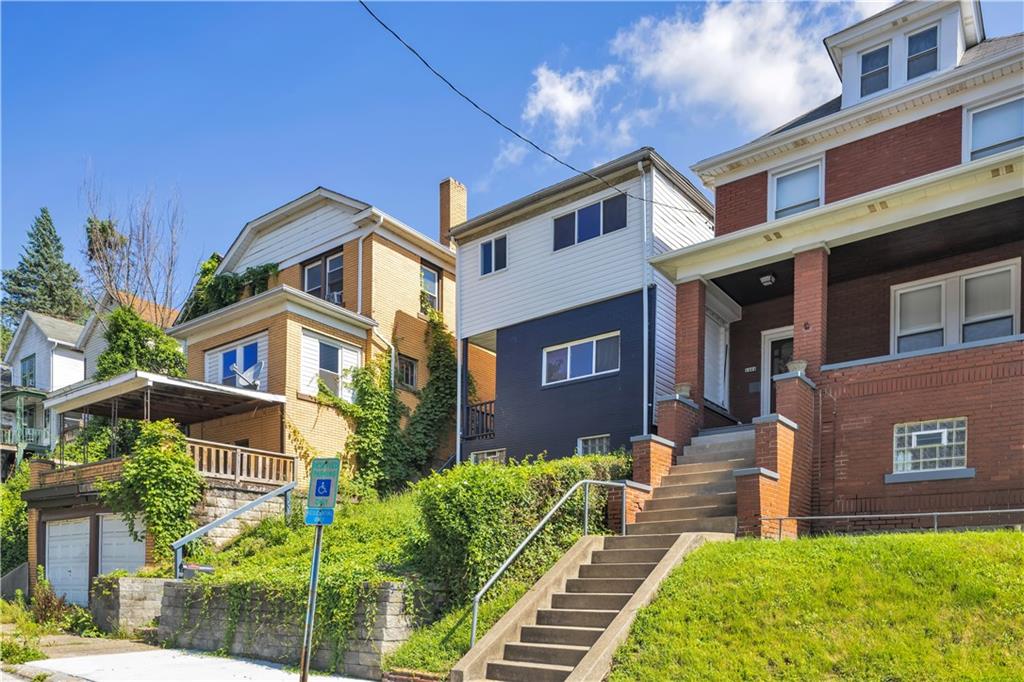 1406 Broadway Avenue McKees Rocks, PA 15136 - Photo 2 of 28 a front view of a house with garden