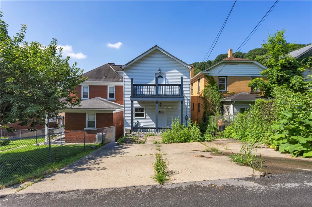 1406 Broadway Avenue McKees Rocks, PA 15136 - Photo 27 of 28 a front view of a house with a yard and garage