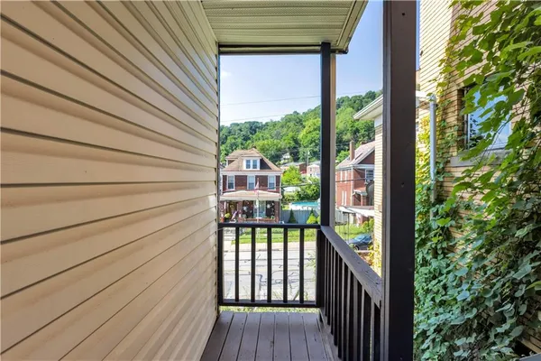 a view of a balcony with wooden floor