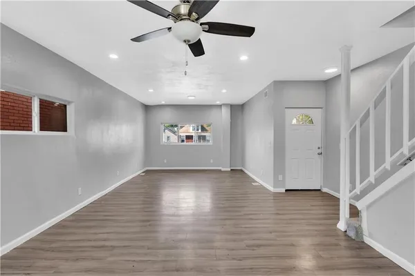 wooden floor in an empty room with a window
