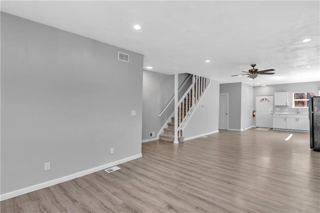 1406 Broadway Avenue McKees Rocks, PA 15136 - Photo 7 of 28 an empty room with wooden floor and staircase