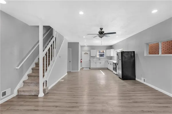 a view of a room with wooden floor and staircase