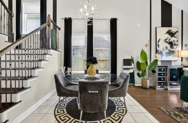 a dining room with furniture window and wooden floor