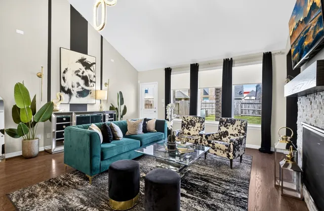 a living room with furniture large window and a flat screen tv