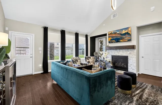 a living room with furniture and a fireplace