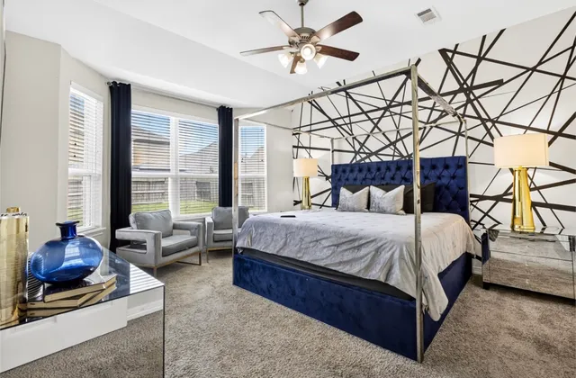 a bedroom with a bed couch and window