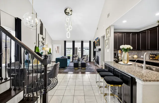 a living room with lots of furniture and a chandelier