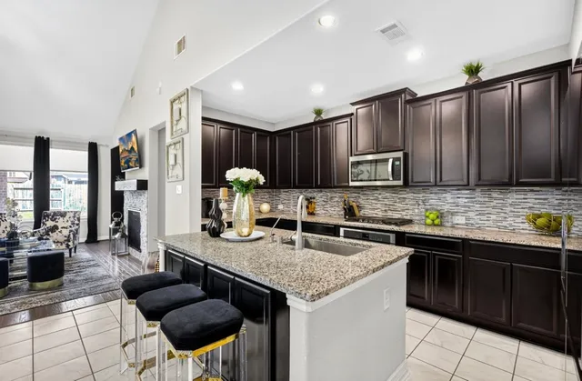 a kitchen with stainless steel appliances granite countertop a sink counter space cabinets and a counter top space