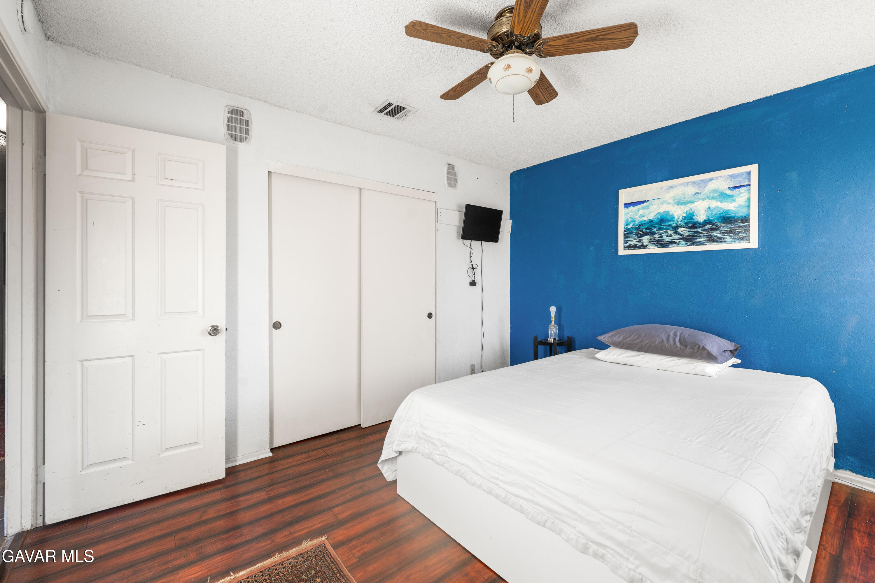 42902 Sachs Drive Lancaster, CA 93536 - Photo 22 of 55 a bedroom with a bed and a painting on the wall