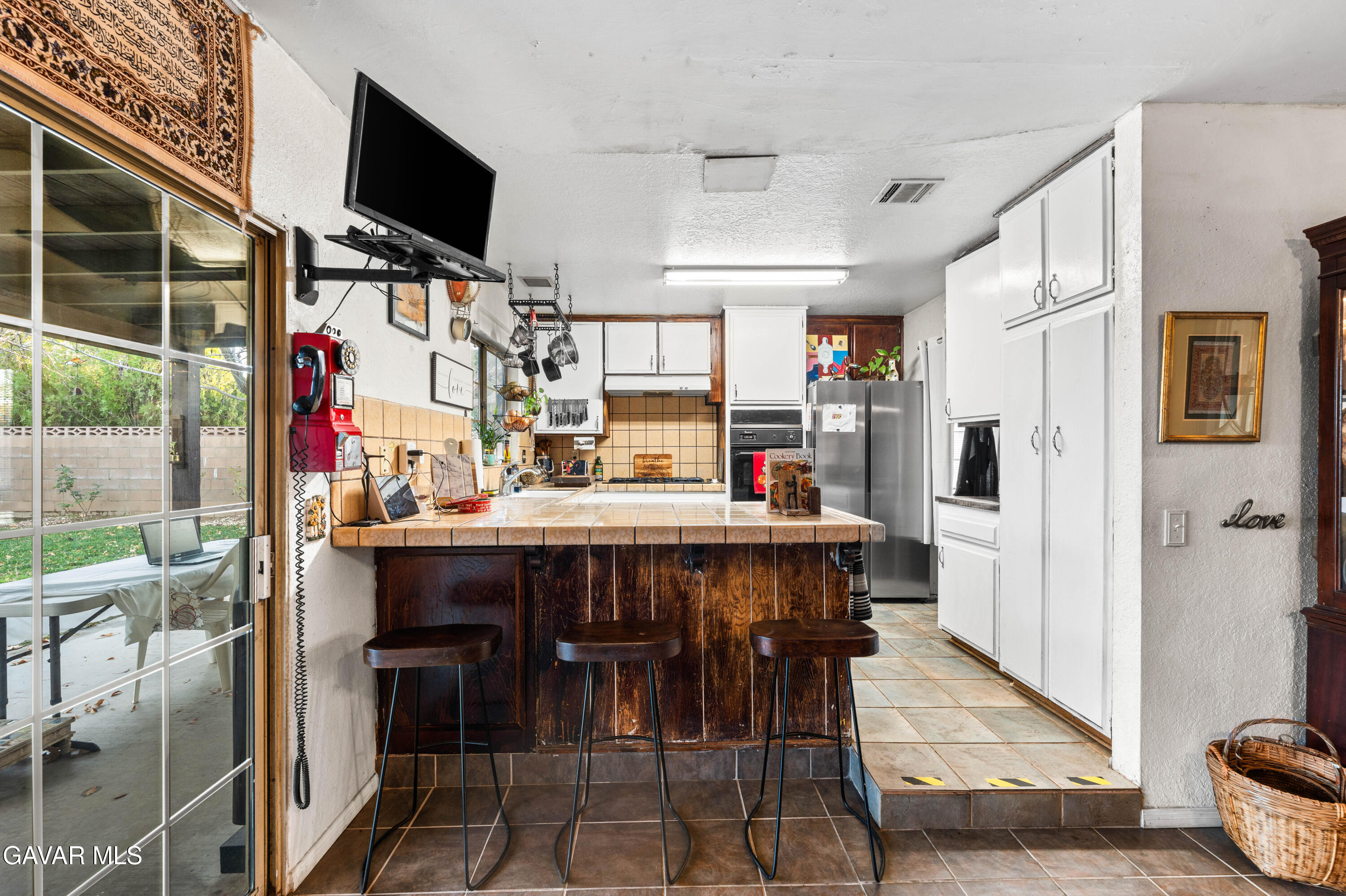42902 Sachs Drive Lancaster, CA 93536 - Photo 28 of 55 a kitchen with stainless steel appliances kitchen island granite countertop a table and chairs in it