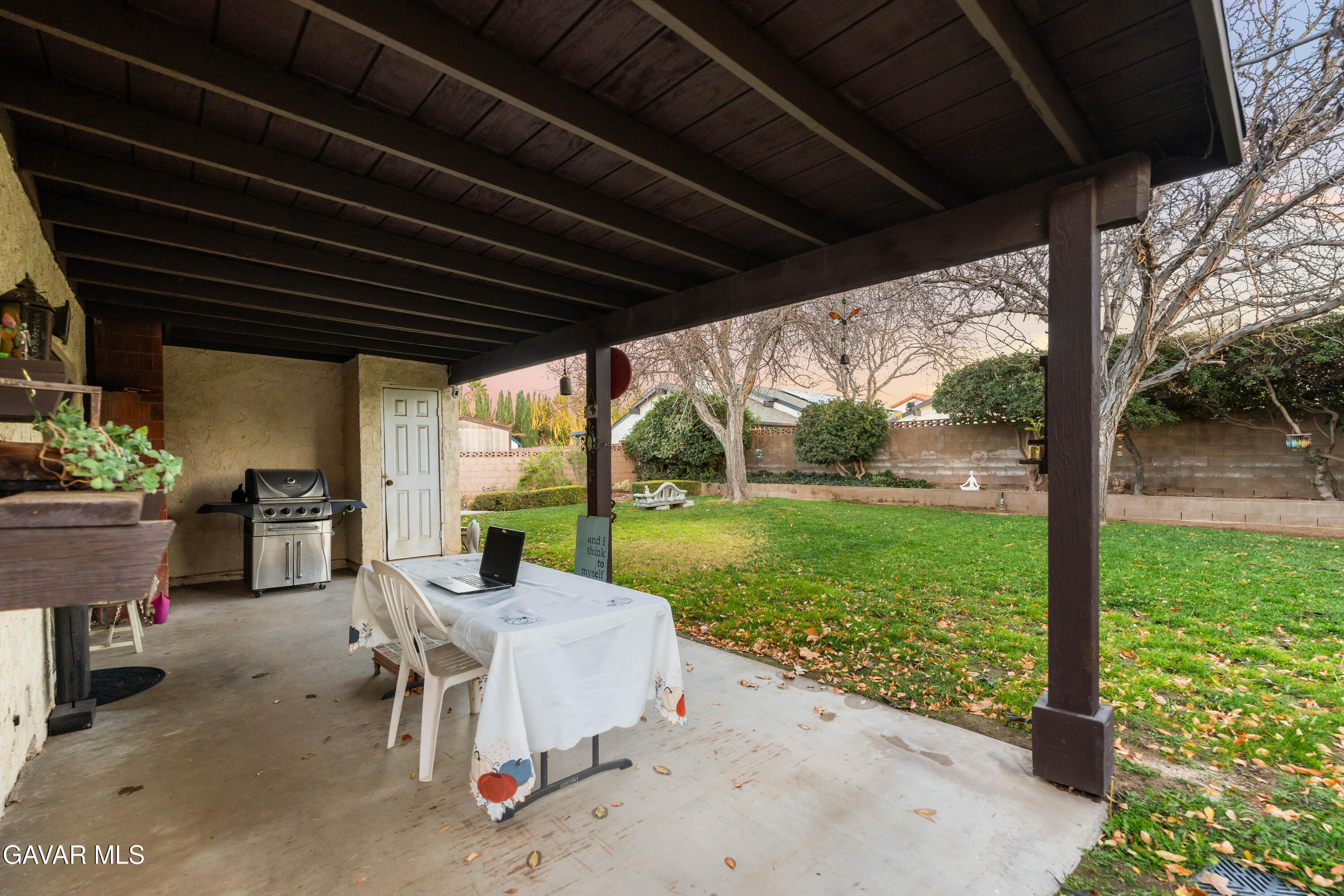 42902 Sachs Drive Lancaster, CA 93536 - Photo 50 of 55 a view of a patio with a table chairs and a backyard
