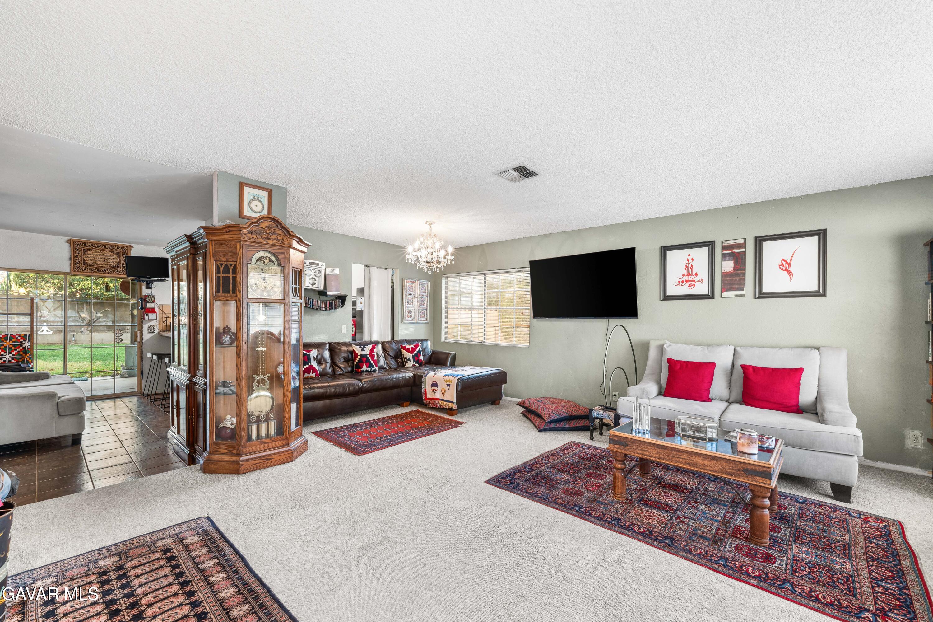 42902 Sachs Drive Lancaster, CA 93536 - Photo 7 of 55 a living room with furniture and a flat screen tv