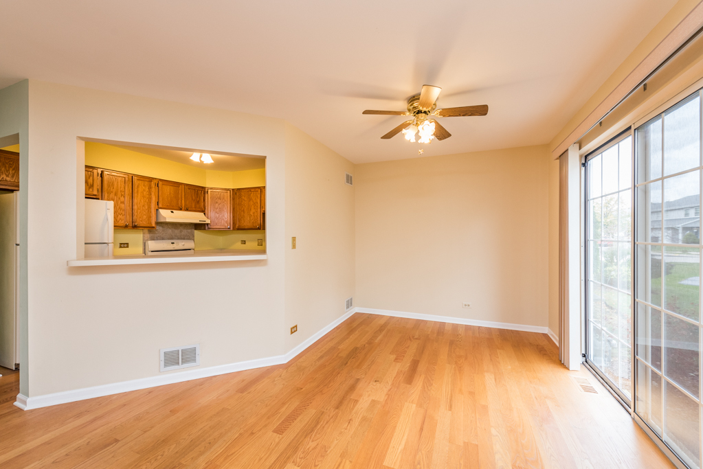 34321 Homestead Road Gurnee, IL 60031 - Photo 11 of 30 a view of a big room with wooden floor and a ceiling fan