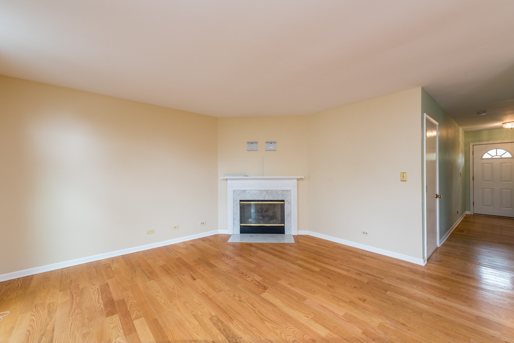 34321 Homestead Road Gurnee, IL 60031 - Photo 8 of 30 a view of empty room with wooden floor and fireplace