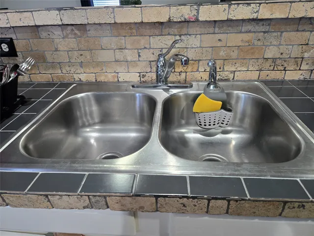 a kitchen with a sink a stove and cabinets