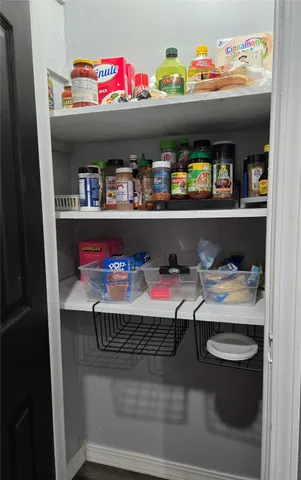 a large bedroom with a bed and a flat tv screen on dresser