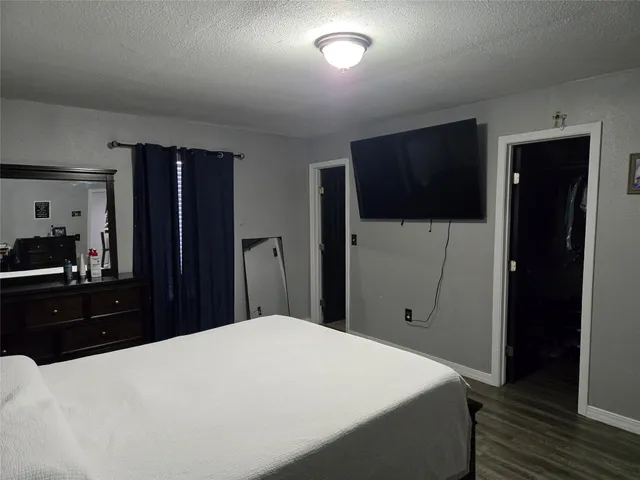 a bedroom with a bed and a table in it