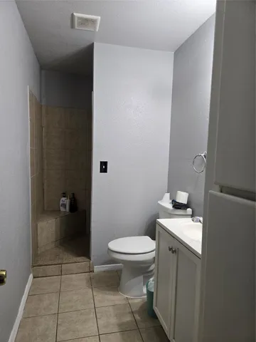 a bathroom with a toilet and a bath tub