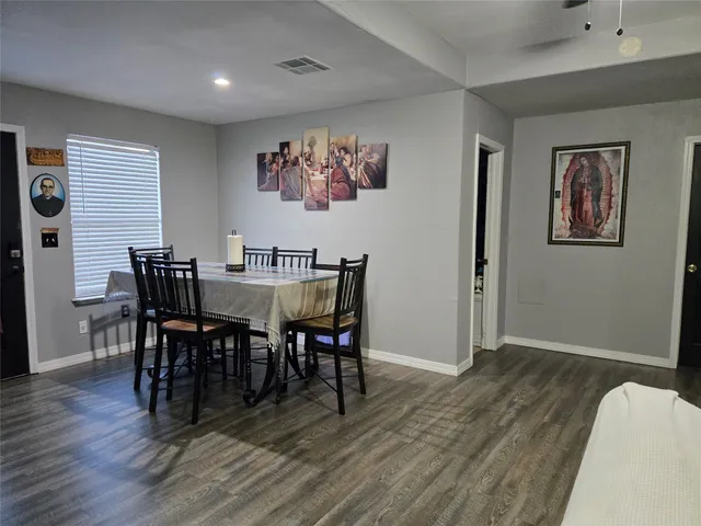 a view of a dining room with furniture wooden floor and chandelier
