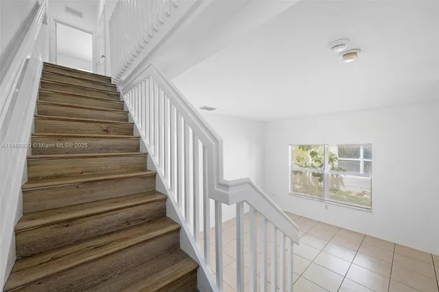 a view of entryway and hall with wooden floor