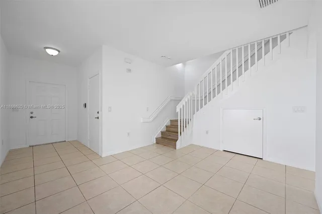 a view of entryway with stairs and a window