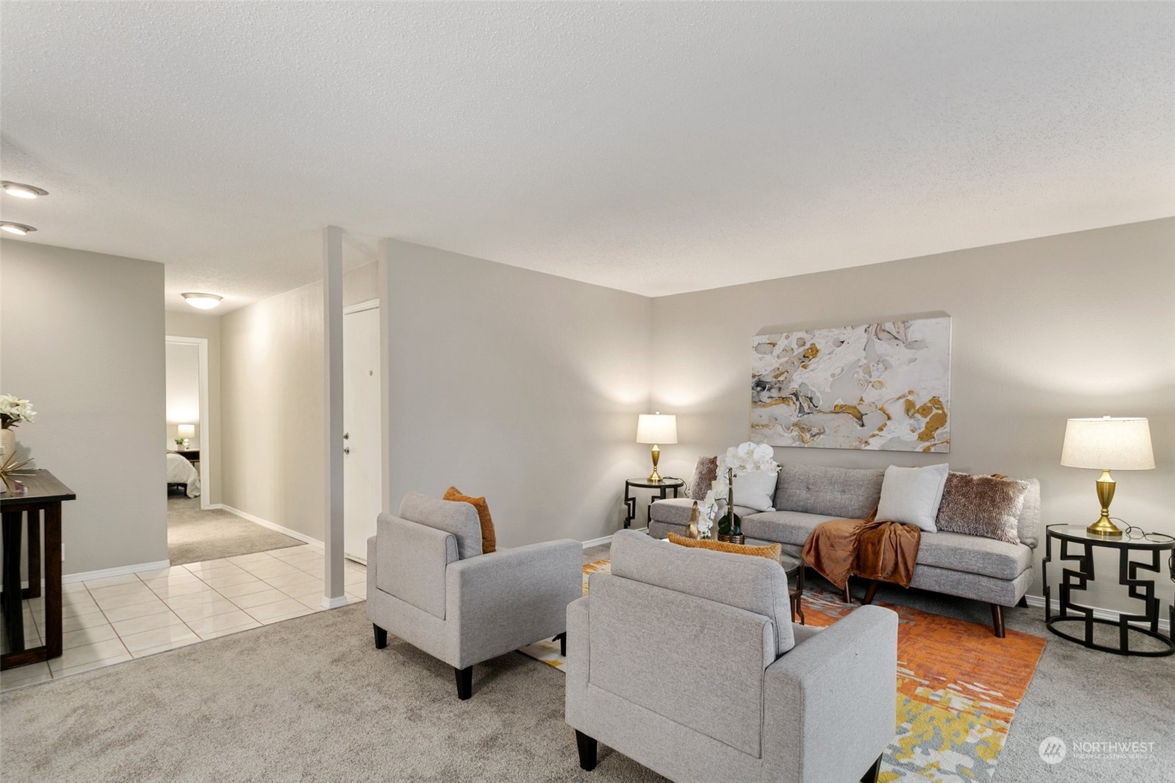 1425 South Puget Drive, Unit H5 Renton, WA 98055 - Photo 14 of 29 a living room with furniture and a chandelier