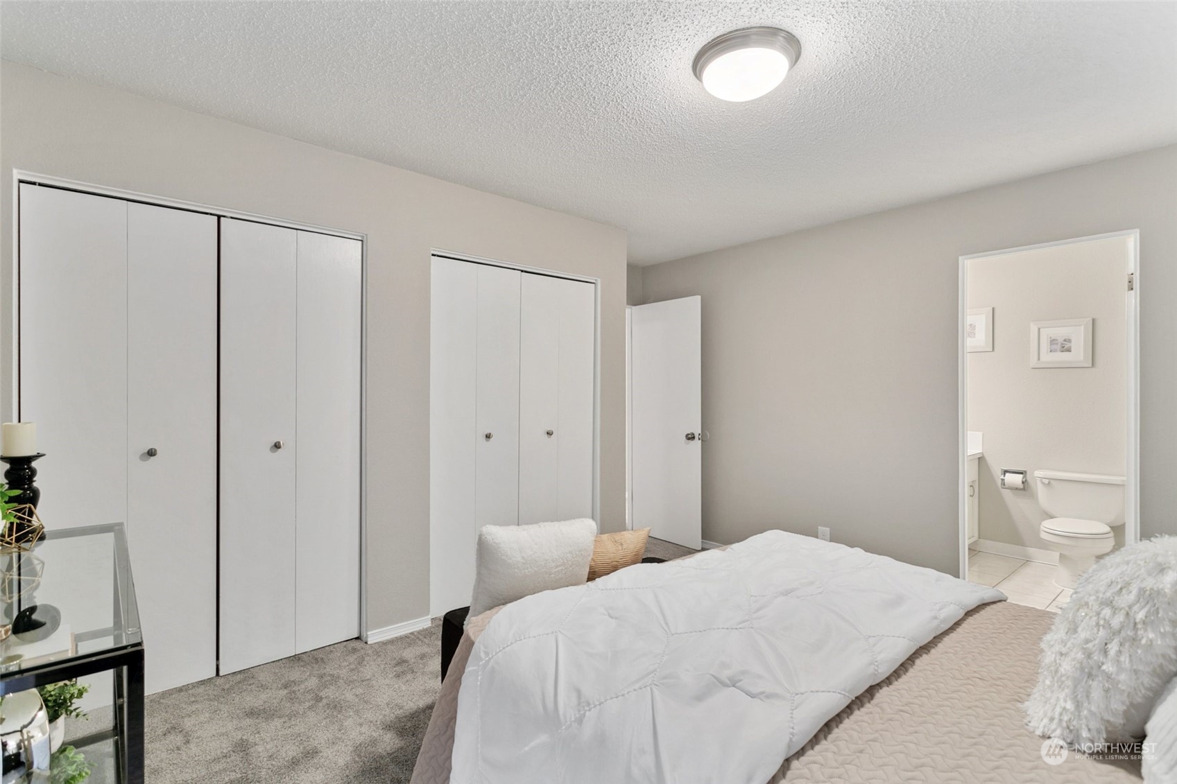 1425 South Puget Drive, Unit H5 Renton, WA 98055 - Photo 19 of 29 a bedroom with a bed and a mirror