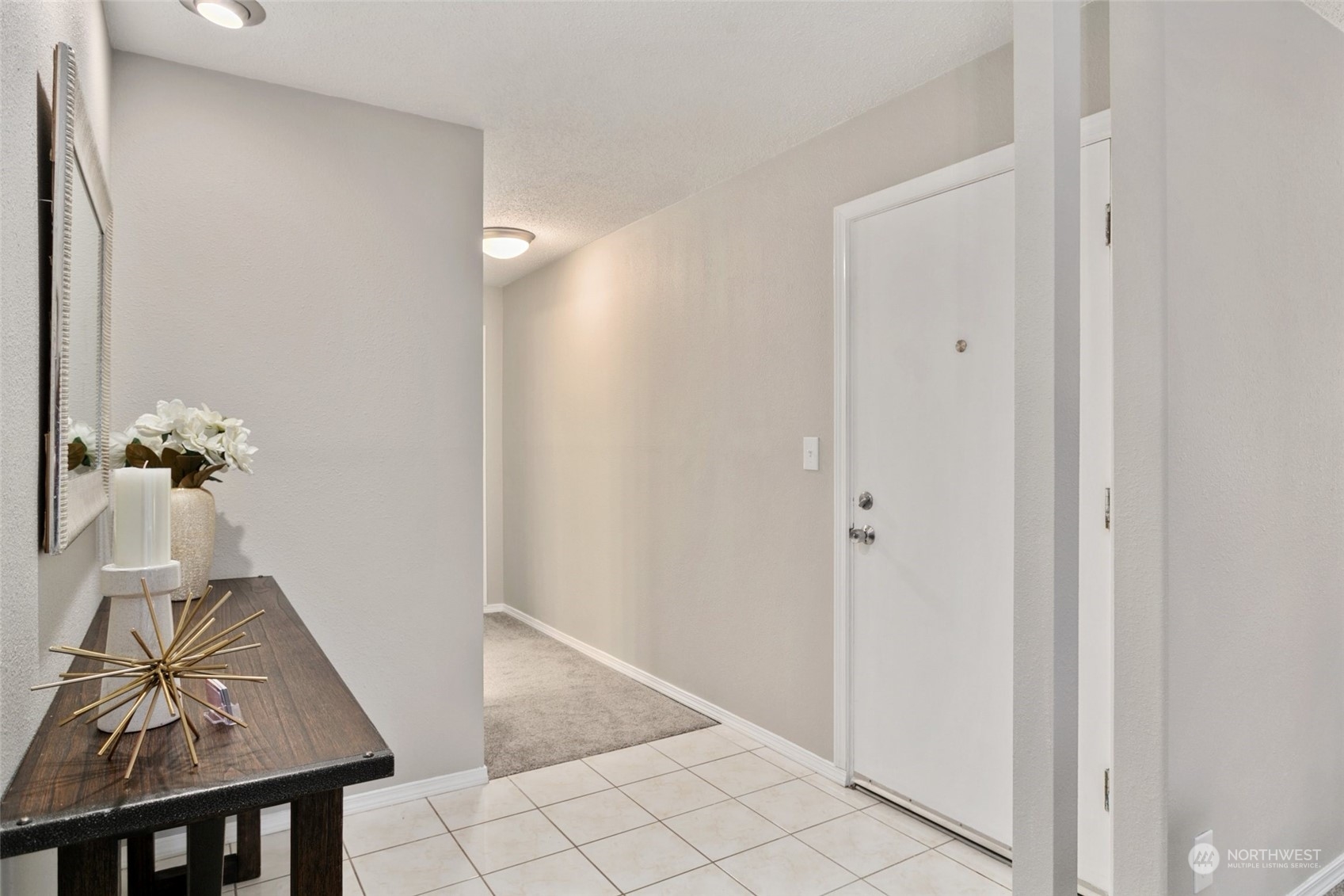 1425 South Puget Drive, Unit H5 Renton, WA 98055 - Photo 21 of 29 a view of hallway with table and a potted plant