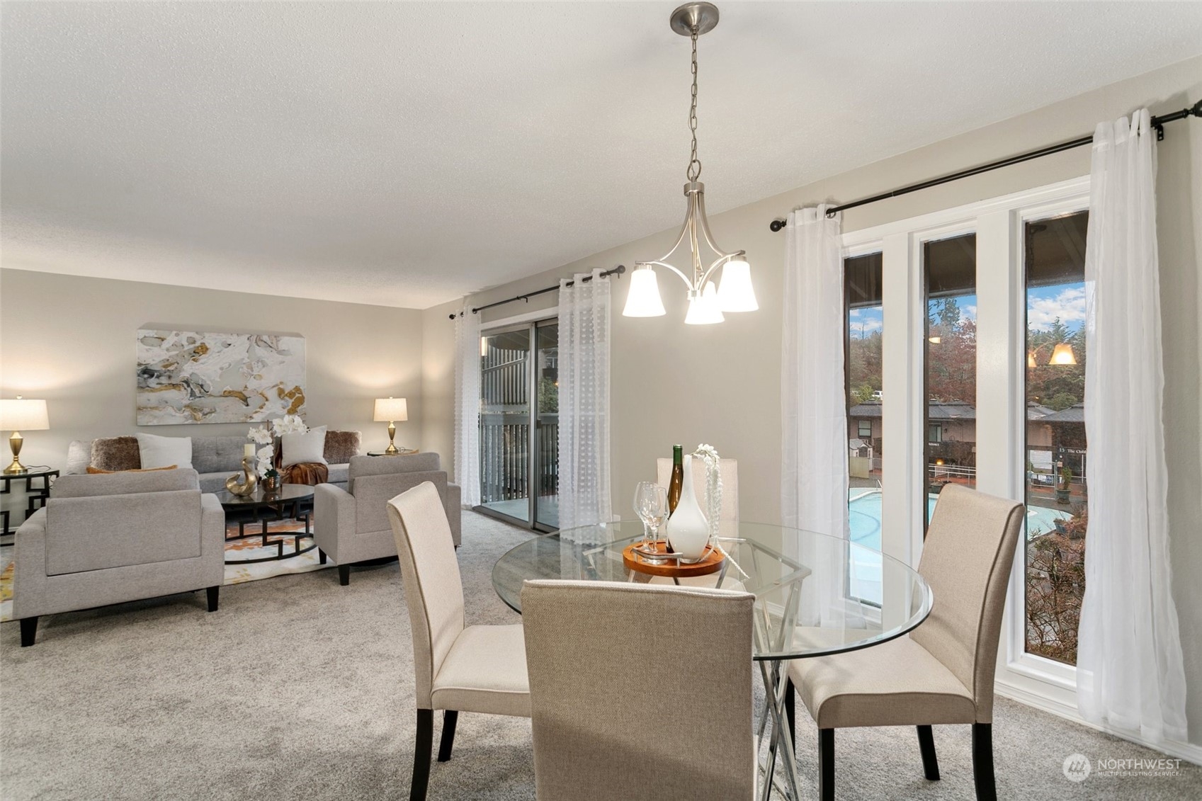 1425 South Puget Drive, Unit H5 Renton, WA 98055 - Photo 6 of 29 a view of a dining room with furniture a livingroom and chandelier