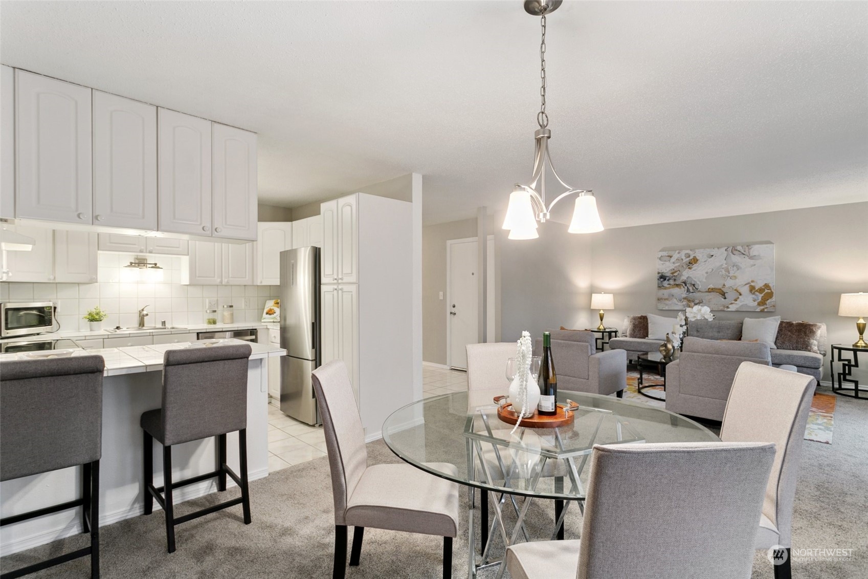 1425 South Puget Drive, Unit H5 Renton, WA 98055 - Photo 8 of 29 a dining room with furniture a chandelier and kitchen view