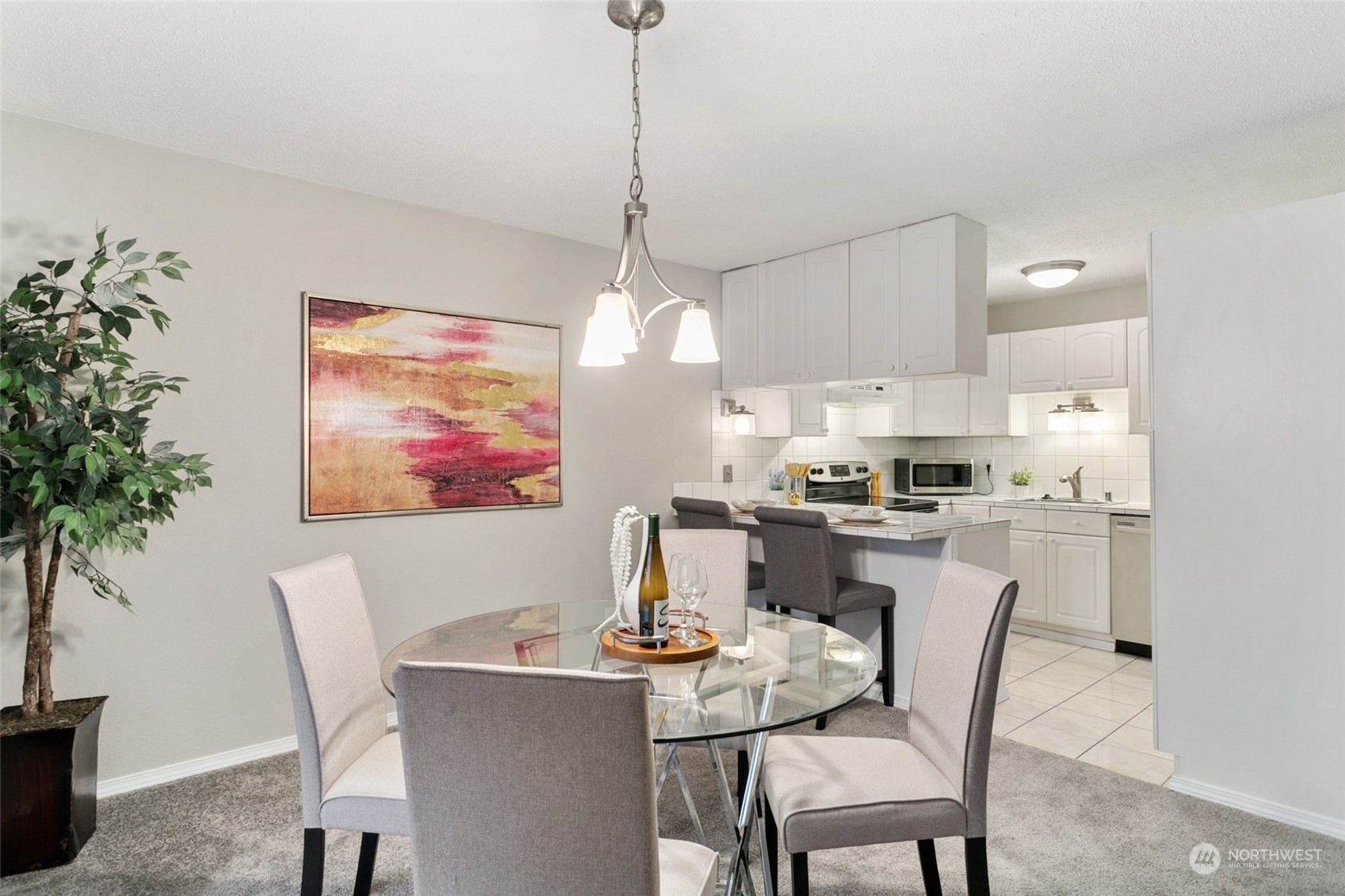 1425 South Puget Drive, Unit H5 Renton, WA 98055 - Photo 9 of 29 a dining room with furniture a chandelier and window