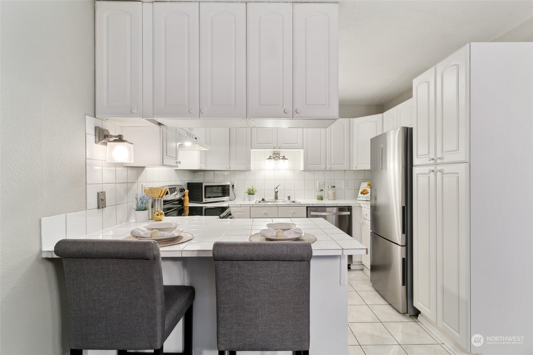 1425 South Puget Drive, Unit H5 Renton, WA 98055 - Photo 10 of 29 a kitchen with a sink a refrigerator and cabinets