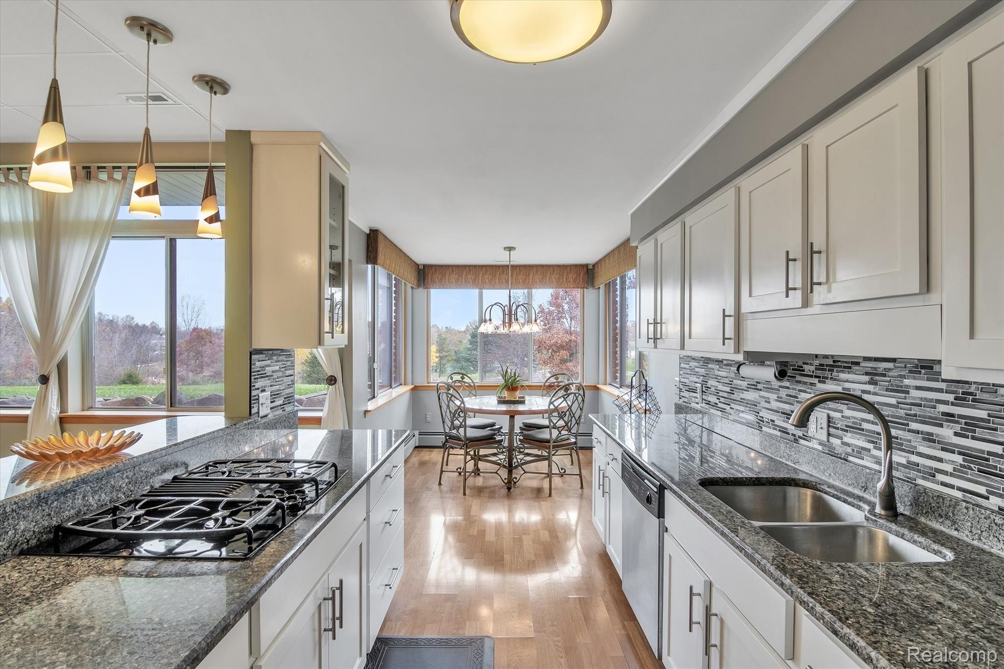 Kitchen with granite countertops, stainless appliances and a view