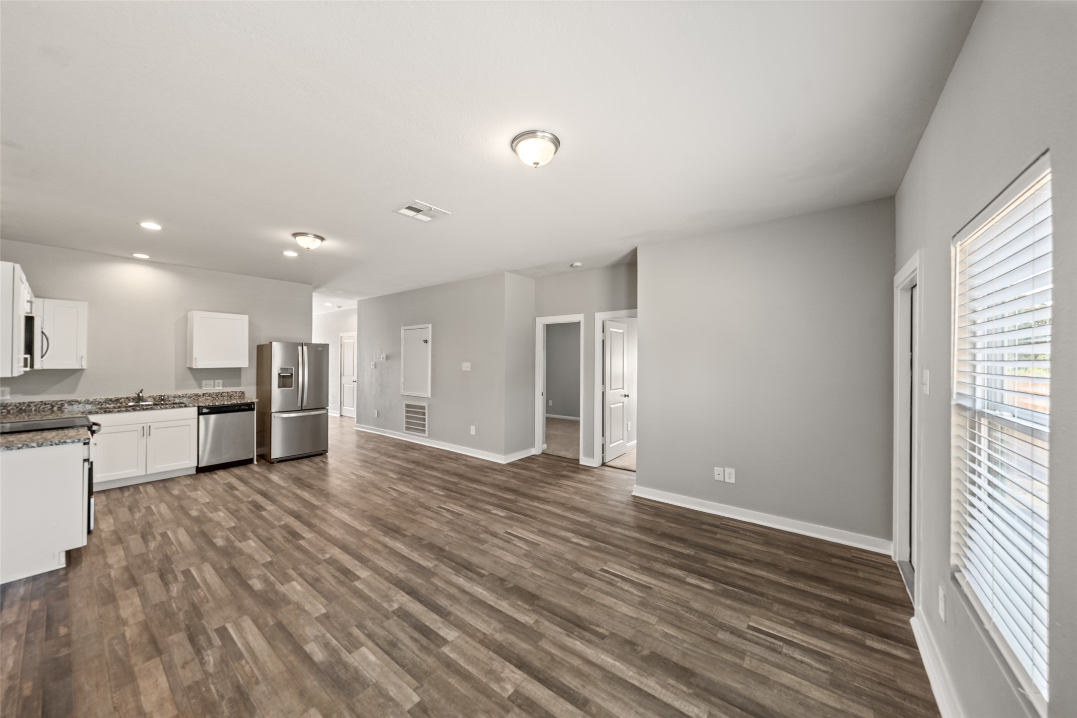 2537 18th Street Hempstead, TX 77445 - Photo 10 of 28 Bright main living area featuring recessed lighting, wood-look flooring, and an open layout designed for everyday living