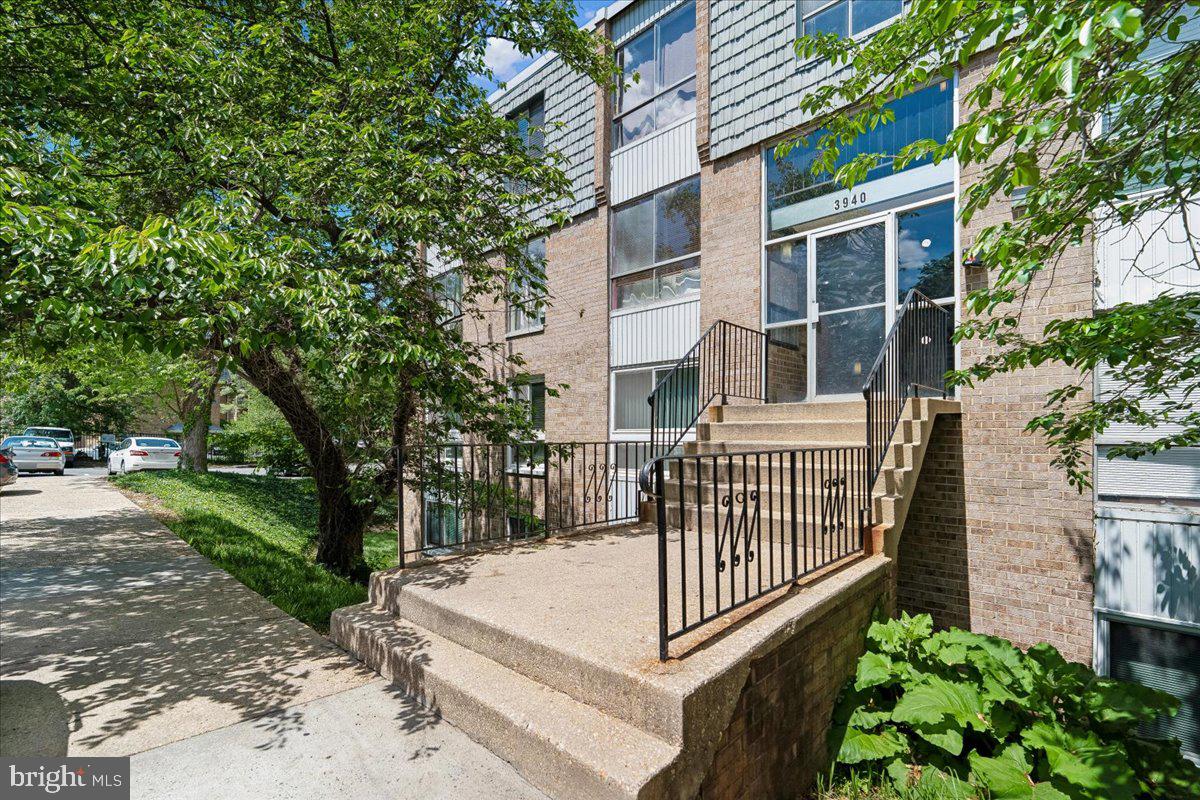 3940 Bel Pre Road, Unit 6 Silver Spring, MD 20906 - Photo 2 of 29 Charming entrance with lush greenery.