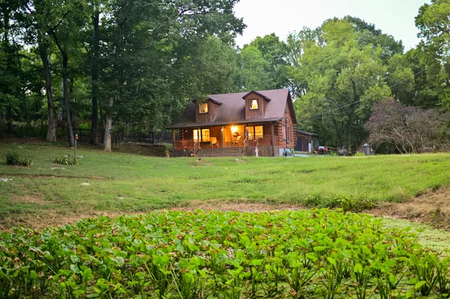 a front view of a house with a garden