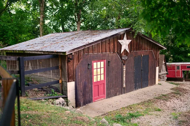 a bedroom with a bed and a flat tv screen on dresser