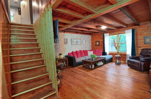 a view of backyard with a barn and large trees