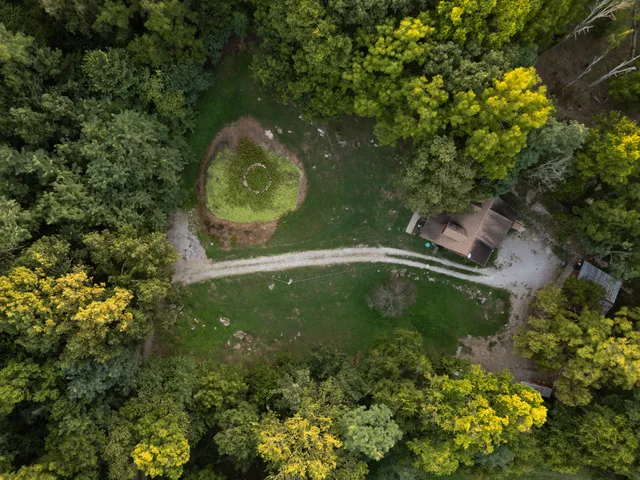 an aerial view of a house with a yard basket ball court and outdoor seating