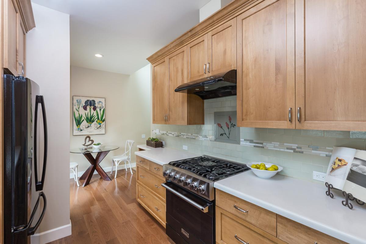 8 Farm Road Los Altos, CA 94024 - Photo 4 of 19 a kitchen with stainless steel appliances a stove a refrigerator a sink a stove and white cabinets with wooden floor