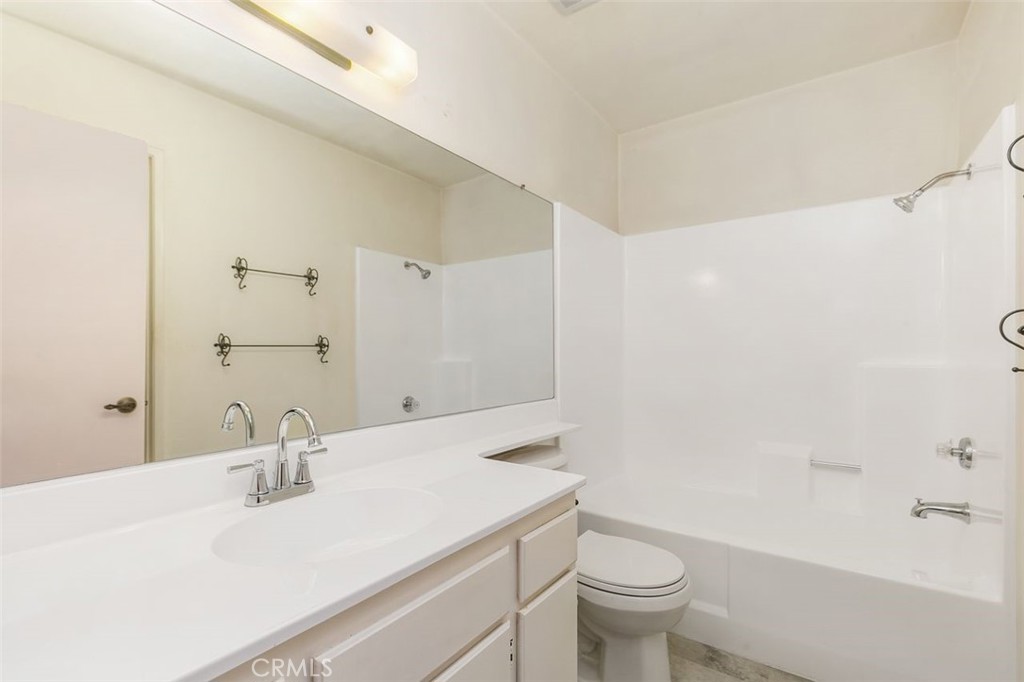 7718 Rambling Brook Way Stanton, CA 90680 - Photo 12 of 23 a bathroom with a sink a toilet and a large mirror