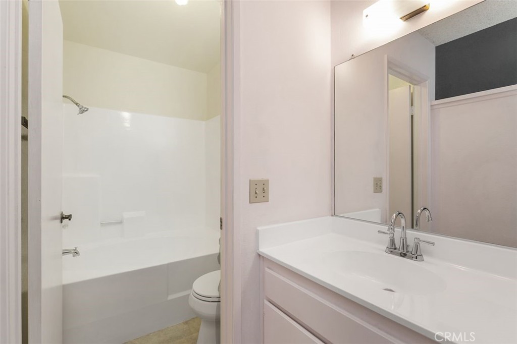 7718 Rambling Brook Way Stanton, CA 90680 - Photo 14 of 23 a bathroom with a sink and a mirror